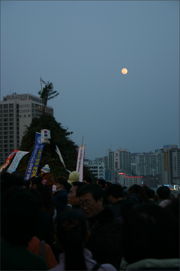 내일을 기다리는 사람들 사이로 달이 떠오른다. 내일을 기다리는 사람들 사이로 달이 떠오른다.
